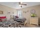 Bright bedroom featuring twin beds with patterned bedding, TV, and simple decor at 1425 Thunderbird Rd, Davenport, FL 33896