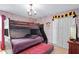 Themed bedroom with bunk beds, stone wallpaper, and Hogwarts decor, perfect for  at 1425 Thunderbird Rd, Davenport, FL 33896