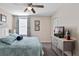 Tranquil bedroom featuring a queen bed with blue bedding, TV, and beach-themed decor at 1425 Thunderbird Rd, Davenport, FL 33896