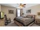 Comfortable bedroom with a rustic wooden bed frame, decorative bedding, and ample natural light at 1425 Thunderbird Rd, Davenport, FL 33896