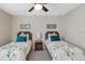 Bright bedroom featuring two twin beds with floral bedding, and simple decor at 1425 Thunderbird Rd, Davenport, FL 33896