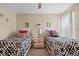 Bright bedroom featuring twin beds with patterned bedding, and simple decor at 1425 Thunderbird Rd, Davenport, FL 33896
