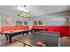 Spacious game room with pool table, ping pong table, and vibrant superhero wall art at 1425 Thunderbird Rd, Davenport, FL 33896