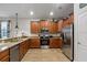 Well-equipped kitchen featuring granite countertops, stainless steel appliances and wood cabinets at 1425 Thunderbird Rd, Davenport, FL 33896