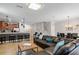Open floor plan showcasing the living room with a large leather sofa, bar seating, and dining area at 1425 Thunderbird Rd, Davenport, FL 33896
