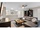 Comfortable loft featuring a sofa, bookshelf, and neutral tones at 1425 Thunderbird Rd, Davenport, FL 33896