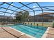 Sparkling screened-in pool and spa with a brick paver deck perfect for outdoor relaxation at 1425 Thunderbird Rd, Davenport, FL 33896