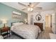 Cozy bedroom featuring a ceiling fan, and complemented by a round mirror at 150 Waterfall Way # 102, Altamonte Springs, FL 32714