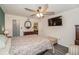 Neutral-toned bedroom with television, ceiling fan, and a striped ottoman at 150 Waterfall Way # 102, Altamonte Springs, FL 32714
