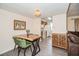 Dining area with live edge wooden table and a view to the kitchen at 150 Waterfall Way # 102, Altamonte Springs, FL 32714