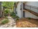 Exterior view of a two-story condo building with stairwell access and lush landscaping at 150 Waterfall Way # 102, Altamonte Springs, FL 32714