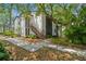 Exterior view of a two-story condo building with stairwell access and mature landscaping at 150 Waterfall Way # 102, Altamonte Springs, FL 32714