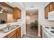 Open concept kitchen with white appliances and a view to the dining area at 150 Waterfall Way # 102, Altamonte Springs, FL 32714