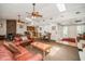 Spacious living room boasts a stone fireplace, skylights, ceiling fans, and a connected bar and dining area at 150 Waterfall Way # 102, Altamonte Springs, FL 32714