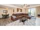 Comfortable living room with modern furnishings, ceiling fan and view into the kitchen at 150 Waterfall Way # 102, Altamonte Springs, FL 32714