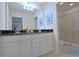 Bathroom featuring dual sinks, granite countertop, and a glass-enclosed shower at 1663 Lima Ave, Kissimmee, FL 34747