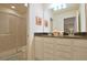 Bright bathroom featuring a double vanity with a dark countertop and tiled shower with glass door at 1663 Lima Ave, Kissimmee, FL 34747