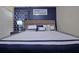 Queen-sized bed with blue and white bedding, matching curtains, and framed artwork above headboard at 1663 Lima Ave, Kissimmee, FL 34747