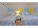 Bright bedroom featuring two twin beds with blue and white patterned bedding, plus a nightstand at 1663 Lima Ave, Kissimmee, FL 34747