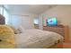 Bedroom featuring a comfortable bed with patterned linens and a wooden dresser at 1663 Lima Ave, Kissimmee, FL 34747