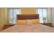 Bedroom featuring a comfortable bed with yellow pillows and matching bedside tables at 1663 Lima Ave, Kissimmee, FL 34747