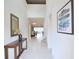 Bright entryway featuring tile floors, high ceilings, a wood table, artwork, and views of the dining area at 1663 Lima Ave, Kissimmee, FL 34747