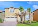Charming two-story home featuring a two-car garage, stone accents, and well-manicured landscaping at 1663 Lima Ave, Kissimmee, FL 34747