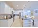 Bright kitchen features granite countertops, stainless steel appliances, and an island with bar seating at 1663 Lima Ave, Kissimmee, FL 34747