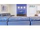 Comfortable living room features a blue leather sofa and a large television for entertainment at 1663 Lima Ave, Kissimmee, FL 34747