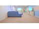 Cozy living room with blue sectional sofa, carpet flooring, and entertainment center at 1663 Lima Ave, Kissimmee, FL 34747