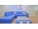 Comfortable living room with a blue sectional sofa and a striped ottoman at 1663 Lima Ave, Kissimmee, FL 34747