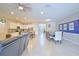 Open-concept living space with tile floors, a dining area, a kitchen with an island, and a Gathering room at 1663 Lima Ave, Kissimmee, FL 34747