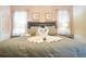 Comfortable king-size bed with ornamental swan towels, decorative pillows and bedside tables at 1663 Lima Ave, Kissimmee, FL 34747