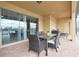 Covered patio featuring a dining table, seating, and lake views, providing an ideal outdoor dining space at 1663 Lima Ave, Kissimmee, FL 34747
