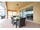 Outdoor patio with dining table, chairs, grill, and screened-in enclosure, perfect for entertaining at 1663 Lima Ave, Kissimmee, FL 34747