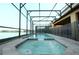 Stunning screened-in pool and spa overlooking the lake, creating a serene and private retreat at 1663 Lima Ave, Kissimmee, FL 34747