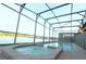 Gorgeous screened-in pool with hot tub overlooking the lake, offering privacy and stunning views at 1663 Lima Ave, Kissimmee, FL 34747