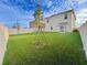 Expansive backyard with lush green grass, new trees, and a white vinyl fence at 1800 Post Oak Dr, Davenport, FL 33837