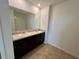 Spacious bathroom featuring double sinks, tile floor, and a large mirror at 1800 Post Oak Dr, Davenport, FL 33837