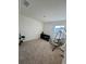 Bright bedroom with neutral carpet, a window, a black shelving unit, and a hanging swing at 1800 Post Oak Dr, Davenport, FL 33837