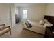 Cozy bedroom featuring carpet, natural light, and simple furnishings at 1800 Post Oak Dr, Davenport, FL 33837