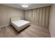 Serene bedroom featuring hardwood floors, decorative molding, and blackout curtains at 18219 Oliver Twist Way, Winter Garden, FL 34787