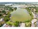 Aerial view of the neighborhood lake showcasing lush landscaping and various community homes at 200 Maitland Ave # 224, Altamonte Springs, FL 32701