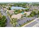 A beautiful aerial view of a condo community with lake, lush landscaping, and ample parking at 200 Maitland Ave # 224, Altamonte Springs, FL 32701