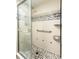 Updated bathroom featuring shower with decorative tile accents, grab bar, and built in storage at 200 Maitland Ave # 224, Altamonte Springs, FL 32701
