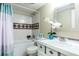 Updated bathroom featuring a shower-tub combination, tiled walls, and decorative mirror at 200 Maitland Ave # 224, Altamonte Springs, FL 32701