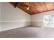 Open living room with vaulted wood plank ceiling, neutral carpet, and window with bright natural light at 200 Maitland Ave # 224, Altamonte Springs, FL 32701