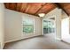Bright living room with a wood ceiling, large windows, and access to a porch, perfect for relaxation at 200 Maitland Ave # 224, Altamonte Springs, FL 32701