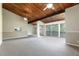 Bright living room with carpet, wood-beamed ceilings, ceiling fans, and sliding glass doors at 200 Maitland Ave # 224, Altamonte Springs, FL 32701