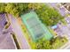 Aerial view of a well-maintained tennis court with trees around the perimeter and parking nearby at 200 Maitland Ave # 224, Altamonte Springs, FL 32701